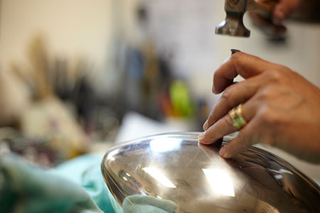 Silversmiths crafting the trophy